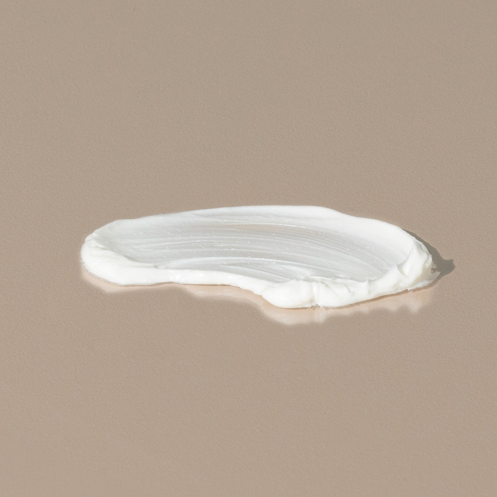 Groom aftershave balm spread of a white creamy texture on a table