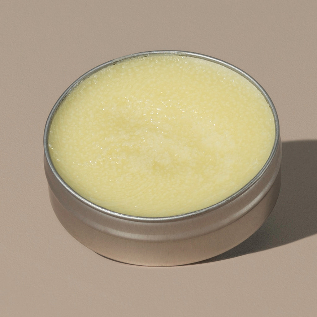 view inside yellow wax creamy Groom beard balm citrus in a rounded metal packaging 