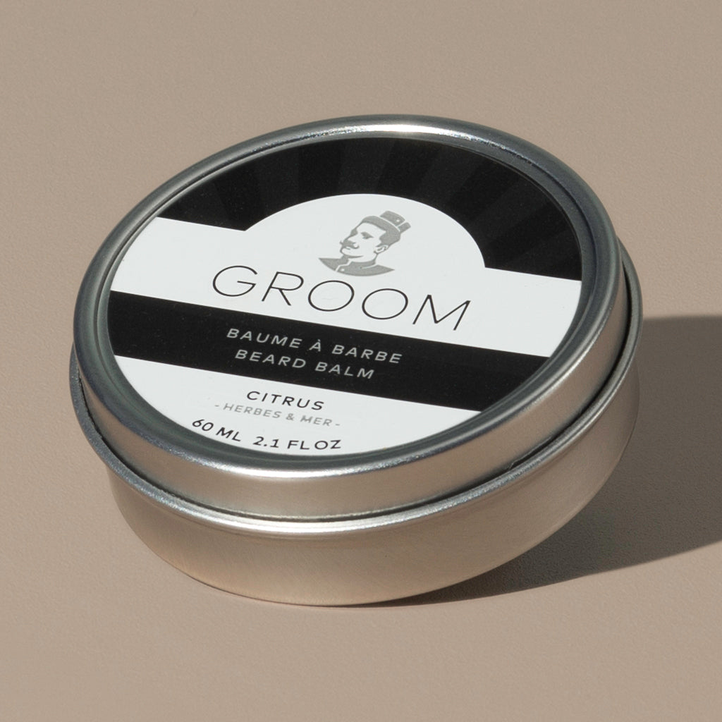 Groom beard balm citrus in a rounded metal packaging with a black and white label of a mustache man