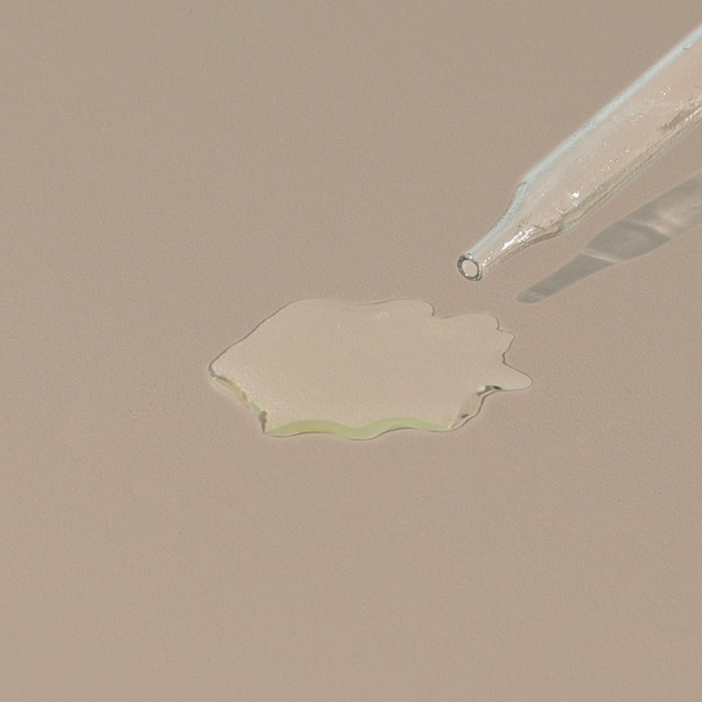 groom shaving oil transparent liquid drop on a table with a glass dropper cap