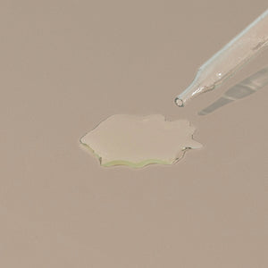 groom shaving oil transparent liquid drop on a table with a glass dropper cap