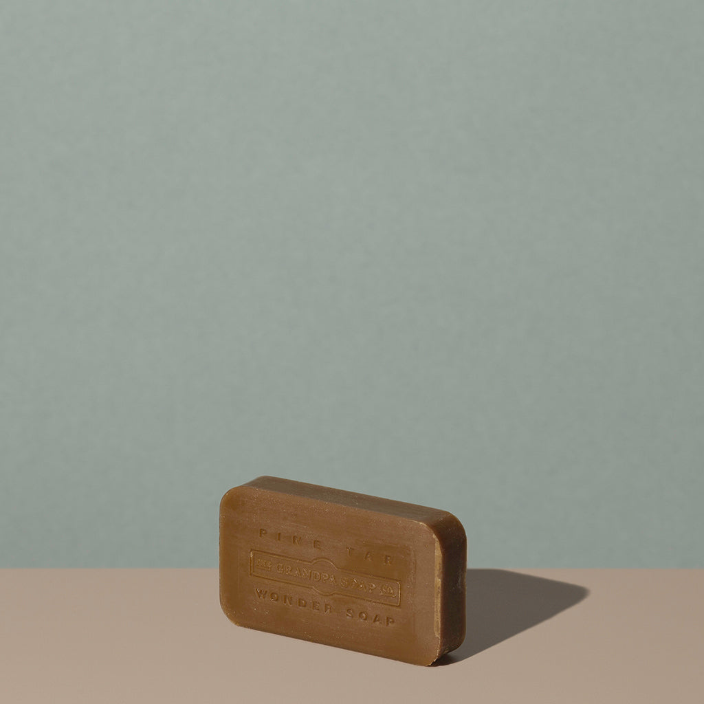 Out of the box The Grandpa Soap Co. brown rounded rectangle bar soap with embossed logo