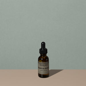 Hudson Made co beard and shave oil cedar clove in a 30ml amber rounded glass bottle with a glass dropper cap and a gray label