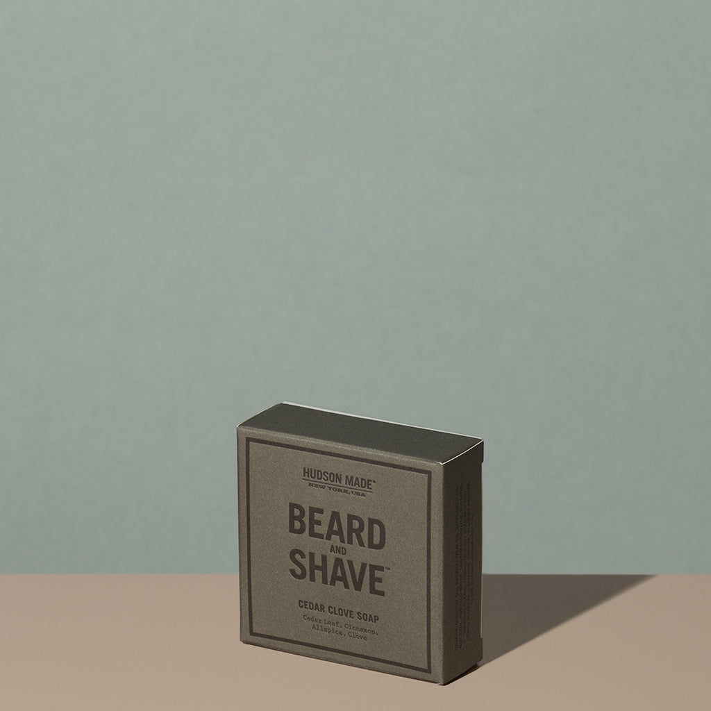 Hudson Made co beard and shave soap cedar clove in a square rectangle gray cardboard packaging with black writings