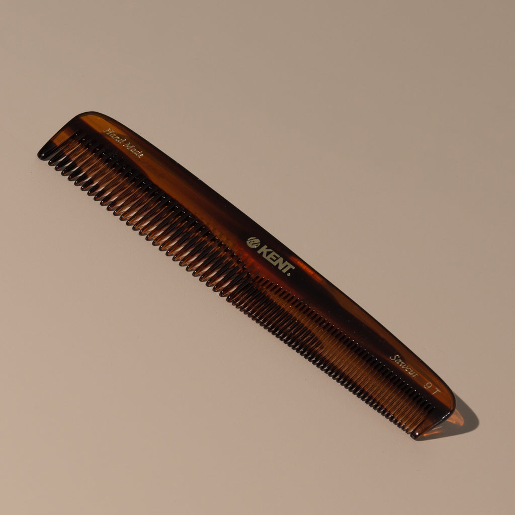 Kent tortoise fine coarse handcrafted 190mm acetate rounded tooth comb for hair or beard with gold label on a table