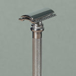Close up details of tall 10 cm Merkur stainless steel Safety Razor with a Long chrome texturized non-slip Handle