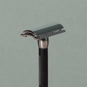 Close up details of Small 8 cm Merkur stainless steel Safety Razor with a texturized non-slip short Black Handle
