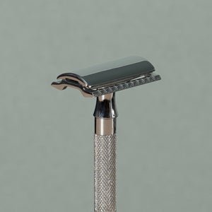 Close up details of Small 8 cm Merkur stainless steel Safety Razor with a texturized non-slip short chrome Handle