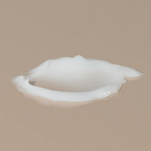Oneka cedar and sage white creamy organic conditionner spread on the table