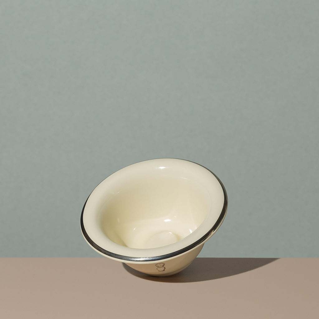 View inside Pure badger shaving porcelain shaving bowl in cream with a silver line on edge and silver logo
