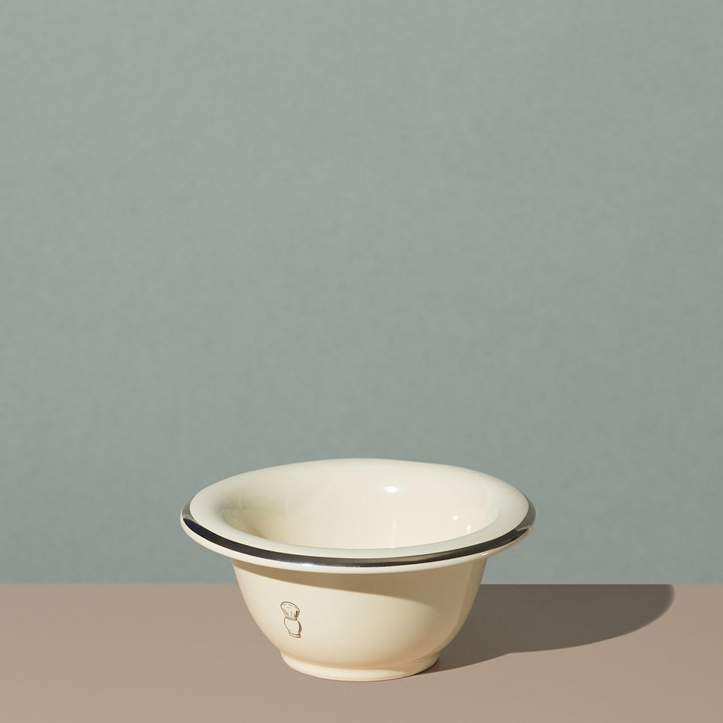 Pure badger shaving porcelain shaving bowl in cream with a silver line on edge and silver logo