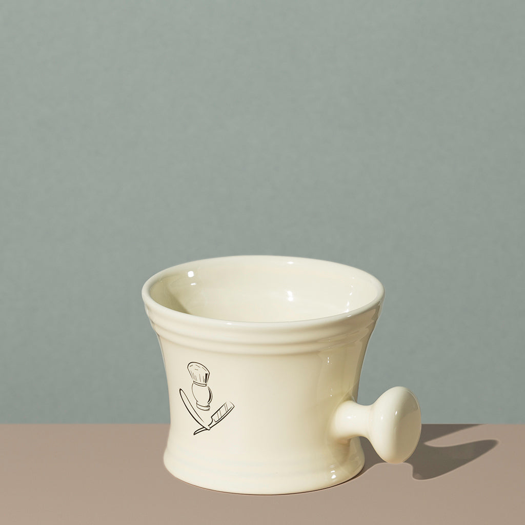 Pure badger shaving porcelain shaving mug with handle in cream with a silver logo