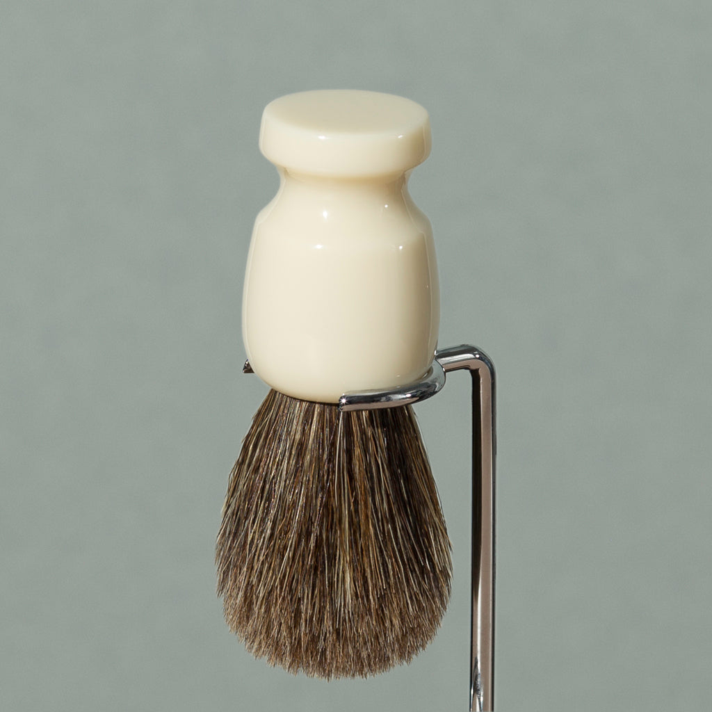 Close up details of Pure badger shaving cream Badger brush stand in chrome stainless steel with round base and rounded head