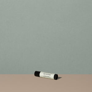 Salt & Stone mint lipstick balm in a small cylindric black lipstick packaging with a black cap and off white labeling with black writings