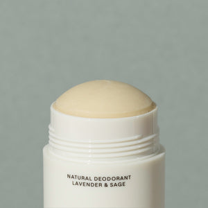 Close up details of beige wax Salt & Stone Natural deodorant lavender and sage in a white cylindric recycled plastic deodorant container with white cap and black writings