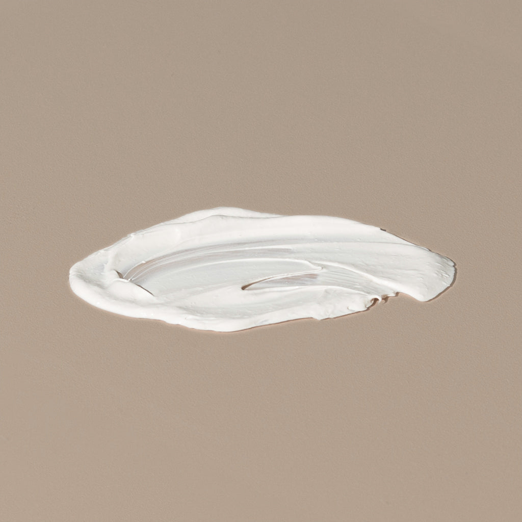 Thinksport 50+ FPS sunscreen white creamy texture spread on a table