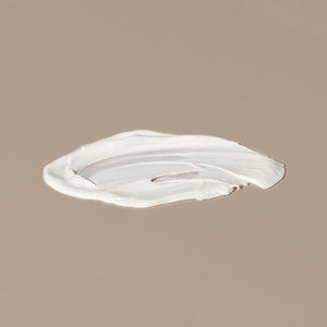 Thinksport 50+ FPS sunscreen white creamy texture spread on a table