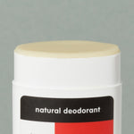 Close up details of creamy wax Thinksport natural deodorant in a white typical rounded square deodorant plastic container with red, black and white logo sticker and a cap