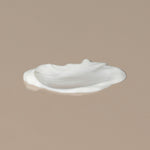 The Unscented Company Plant based hydrating lotion white creamy texture spread on a table